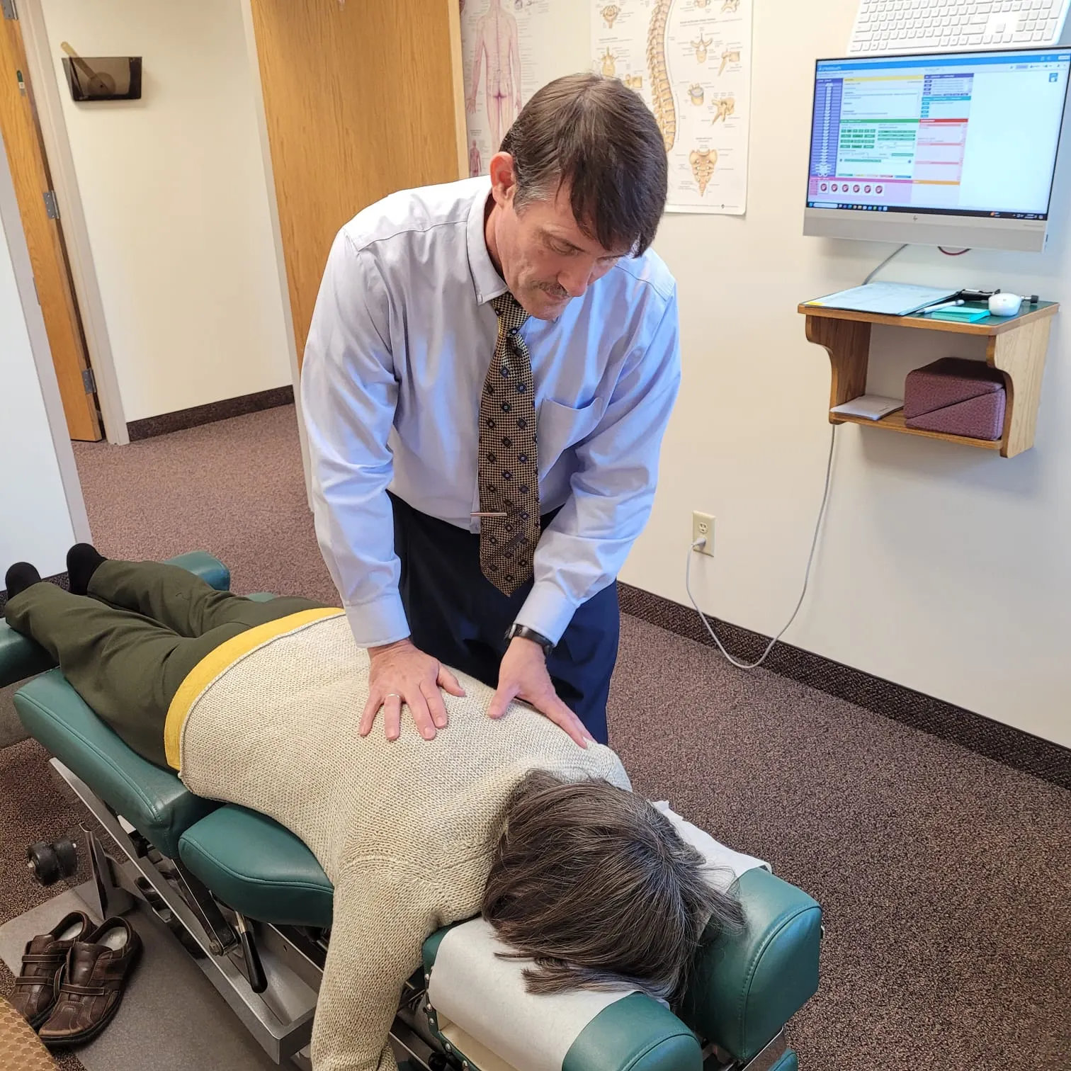Dr. Endris performing a gentle spinal adjustment on a patient's back